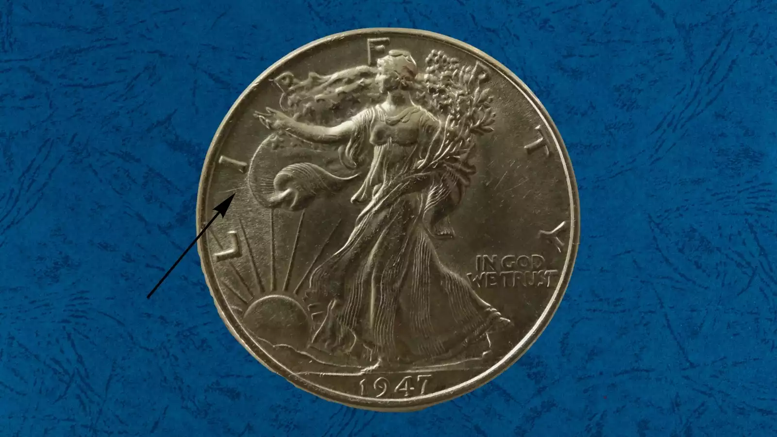 1947 Walking Liberty half dollar die cud error showing raised featureless lump at coin rim where die broke